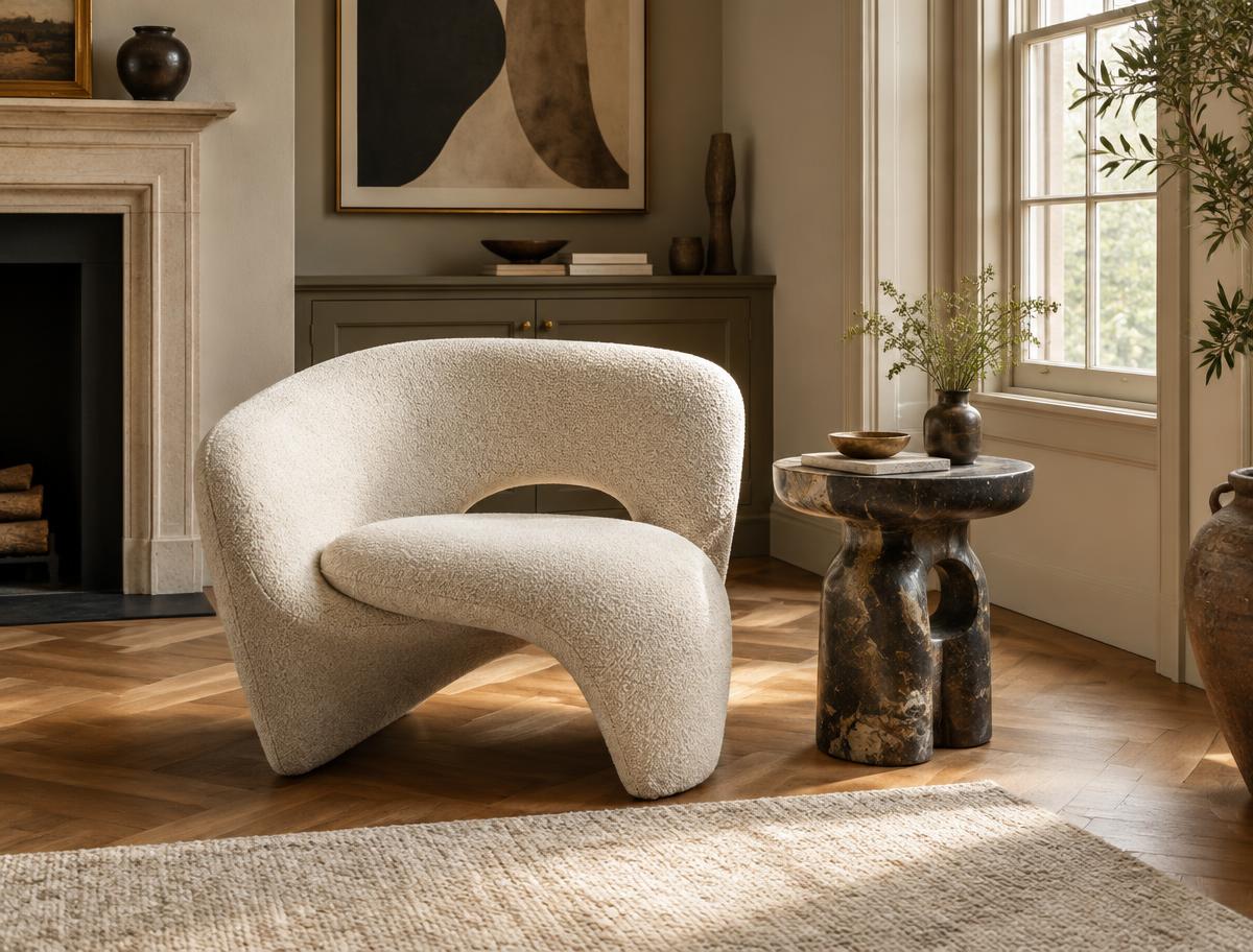 A distinctive sculptural chair and crafted side table in an elegant room